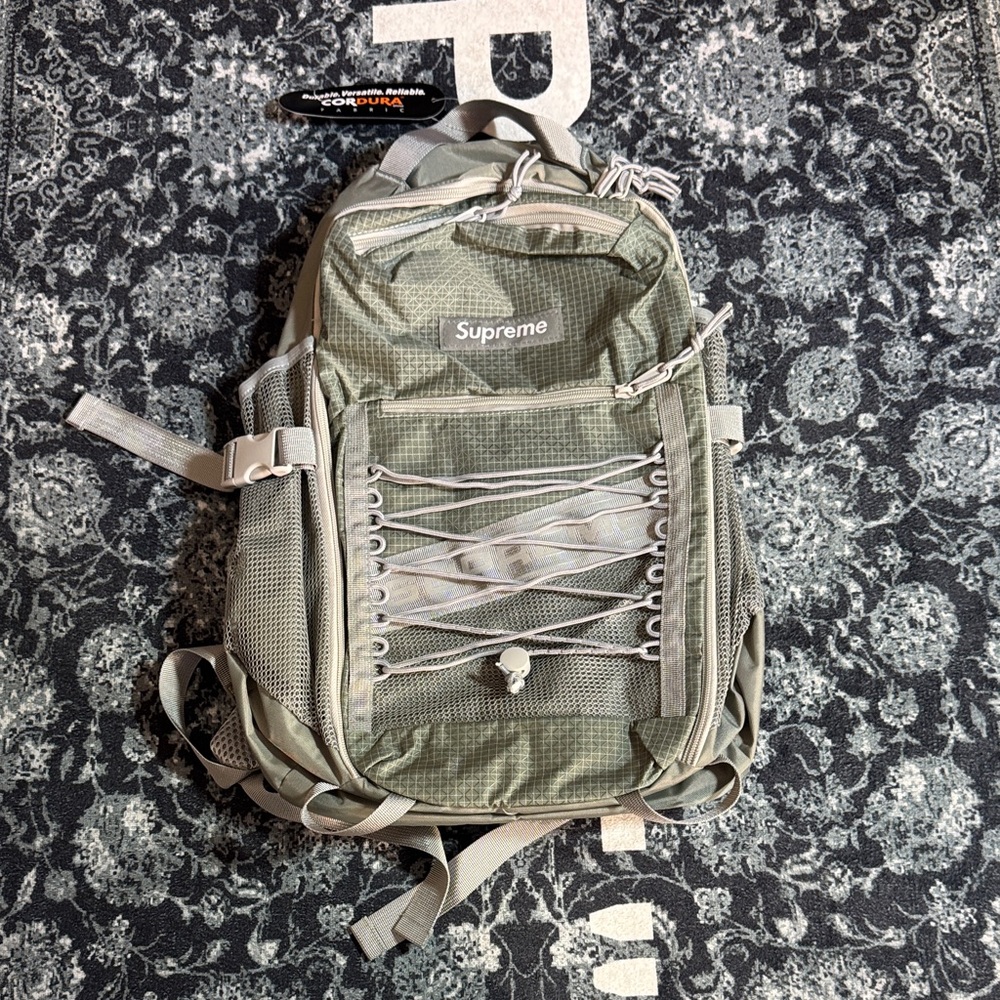 Supreme Gray Silver Tactical Backpack with Front Bungee and Multiple Pockets